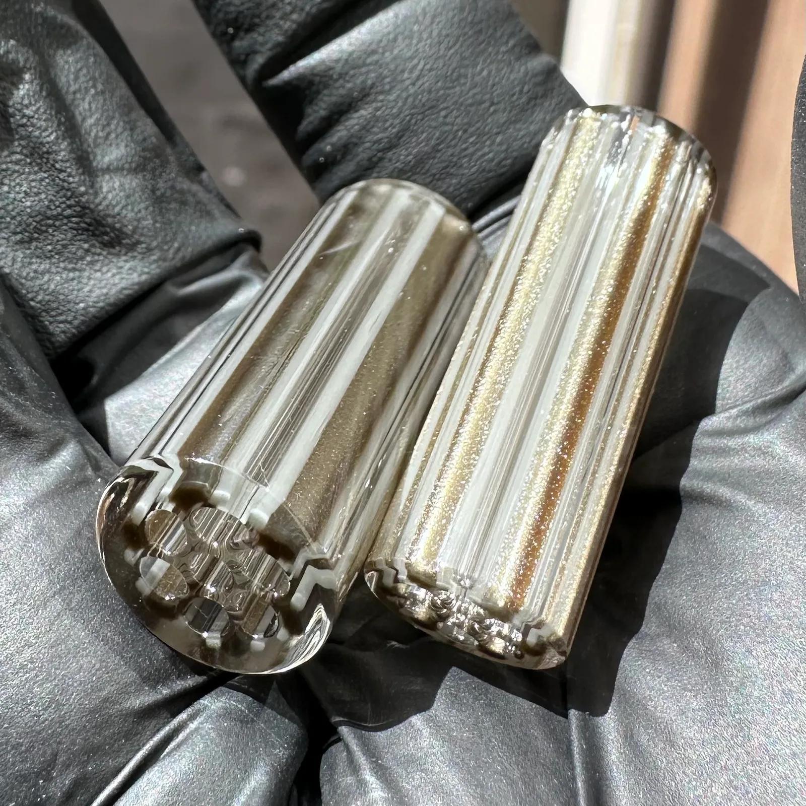 Electrum Grey glass tips shown in hand for size reference