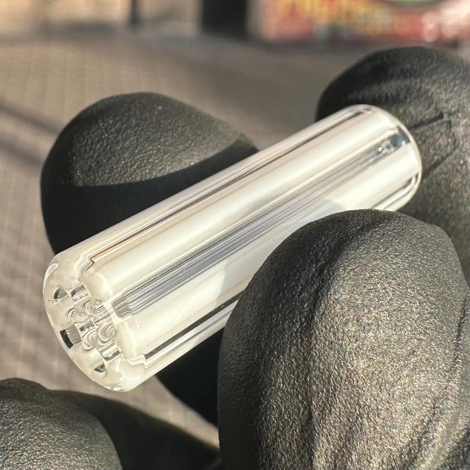 Mr. White borosilicate glass tips shown in hand for size reference